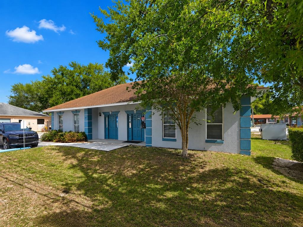 A single-story building with a gray exterior, blue trim, and two front doors — 631 E OAK RIDGE ROAD, ORLANDO, FL
