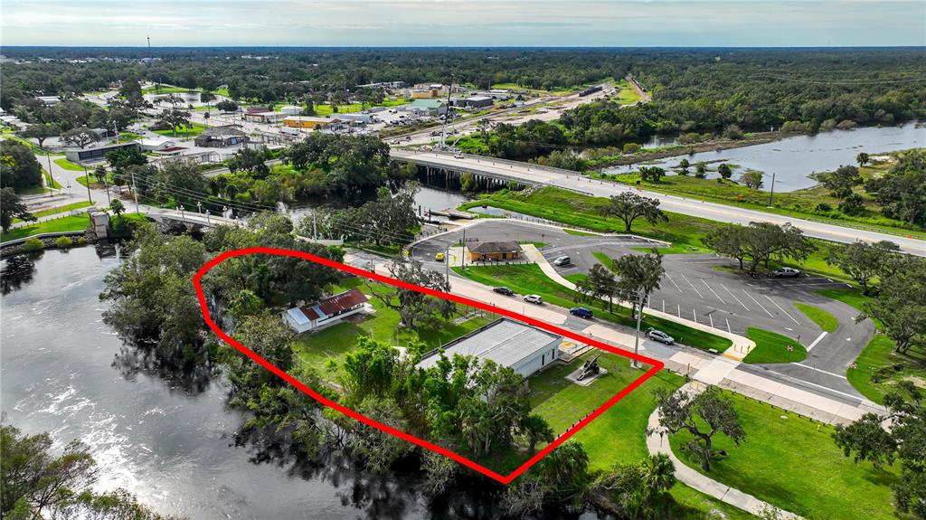 An aerial view shows a waterfront property with two buildings and a small cannon — 2124 NW AMERICAN LEGION DRIVE, ARCADIA, FL