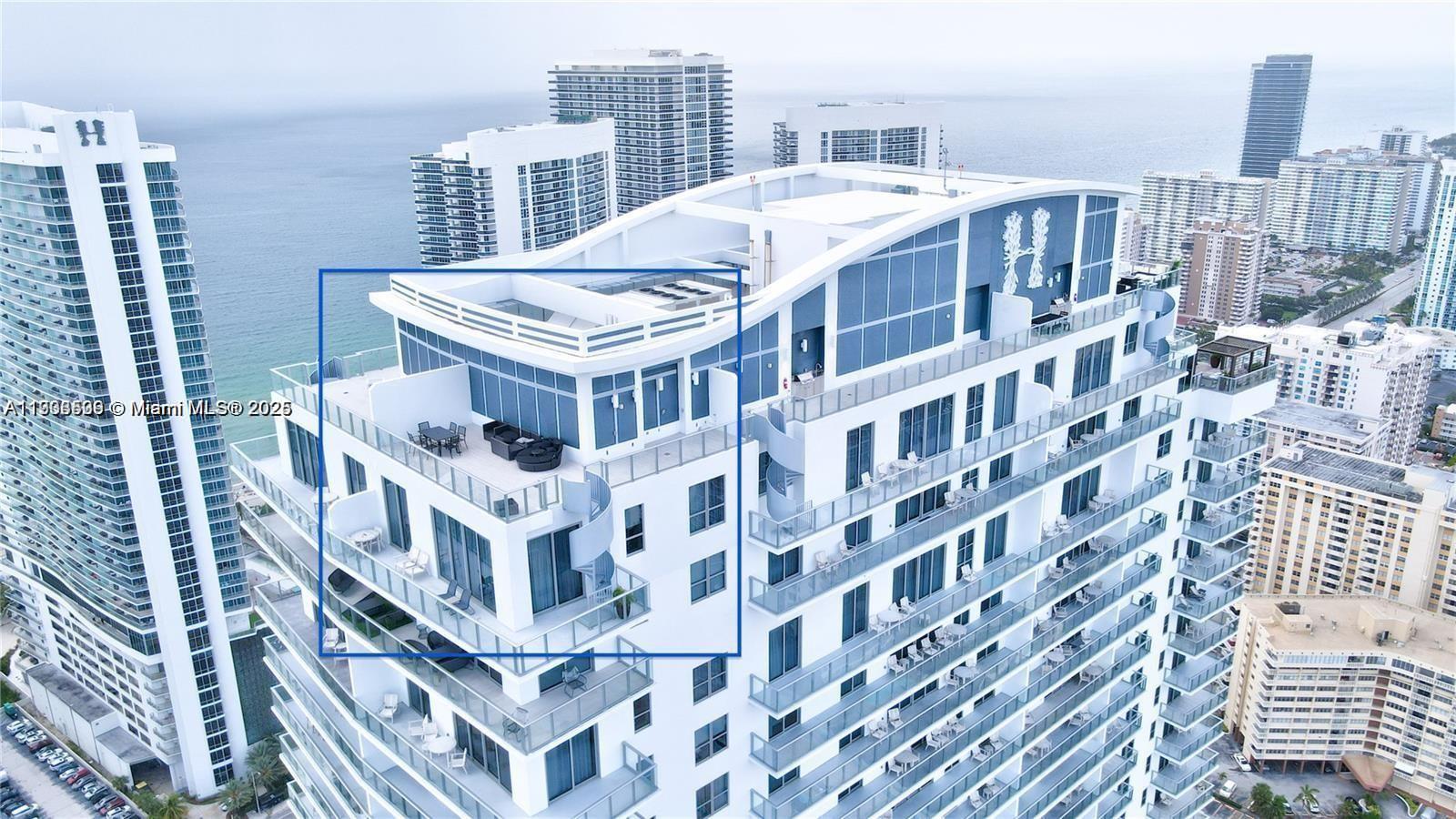 An aerial view shows the top floors and rooftop terrace of a modern coastal high-rise building — 4010 S Ocean Dr # T4302, Hollywood FL 33019, HOLLYWOOD, FL