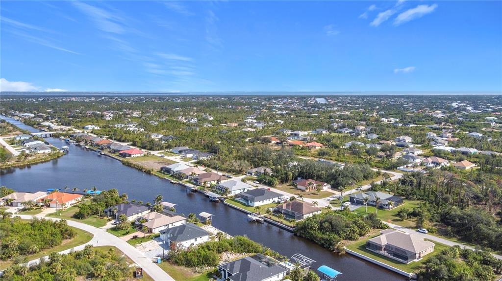 An aerial view shows houses along a canal in a residential neighborhood — 9177 SANTA LUCIA DRIVE, PORT CHARLOTTE, FL