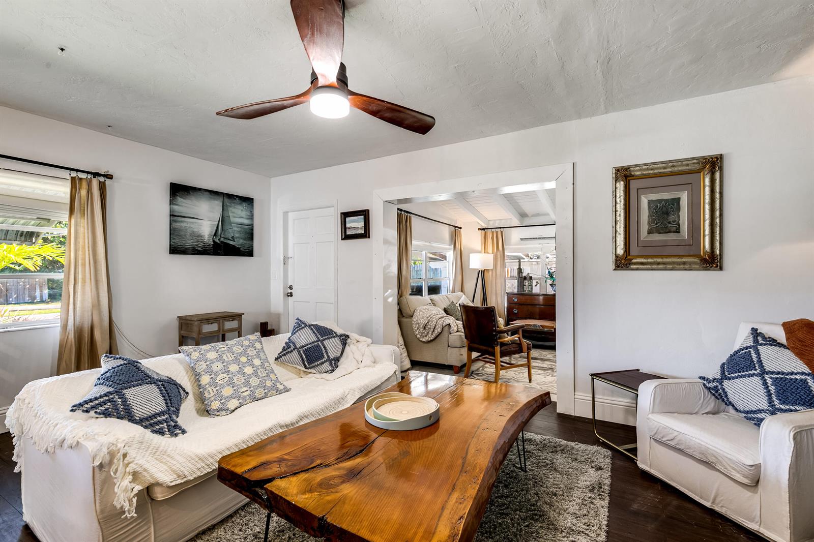 A living room features a live-edge wooden coffee table, white sofas, and a ceiling fan — 609 S Arnold Avenue, Lantana FL 33462, LANTANA, FL