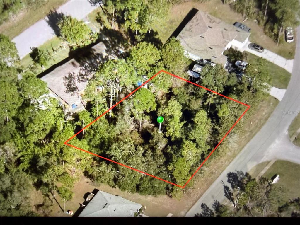 An aerial view shows a wooded, rectangular vacant lot outlined in red — 2952 DAY ROAD, DELTONA, FL