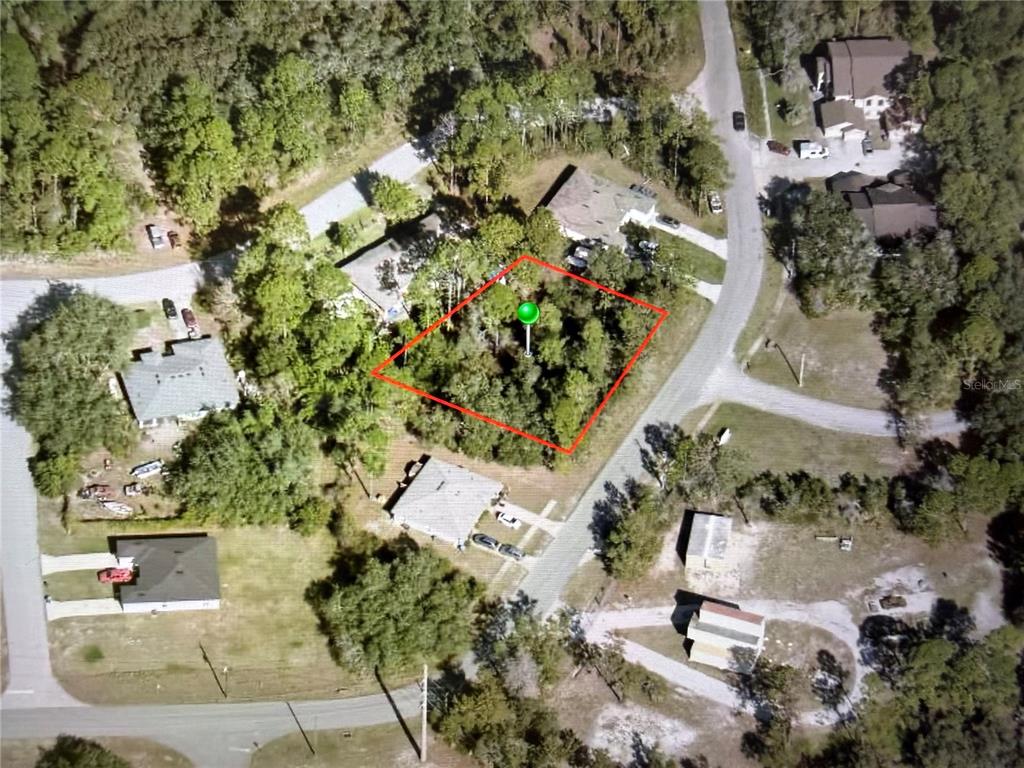 An aerial view shows a wooded, rectangular vacant lot outlined in red — 2952 DAY ROAD, DELTONA, FL