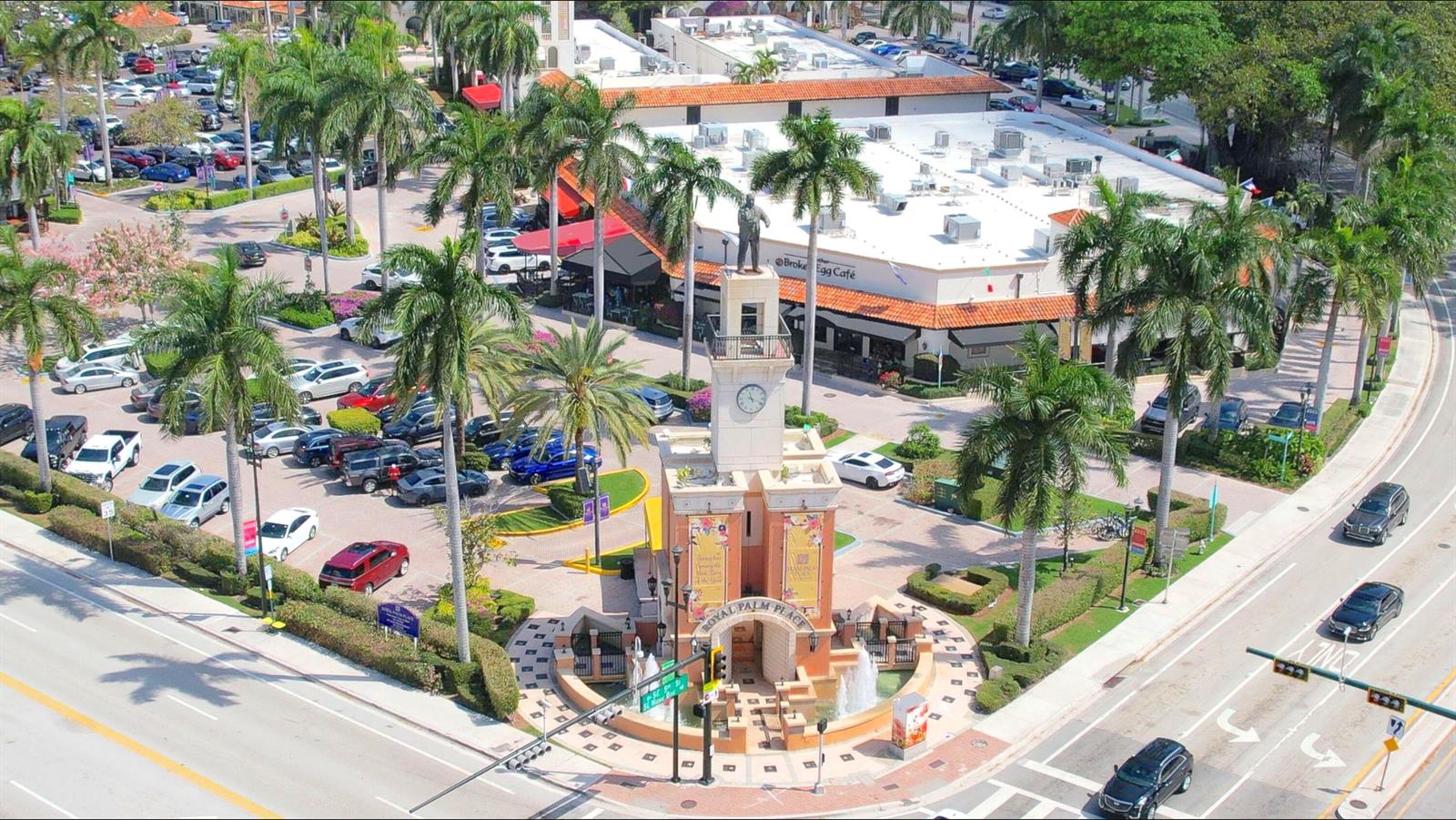 An aerial view shows a clock tower monument in a plaza surrounded by parking lots — 101 Plaza Real S # 829, Boca Raton FL 33432, BOCA RATON, FL