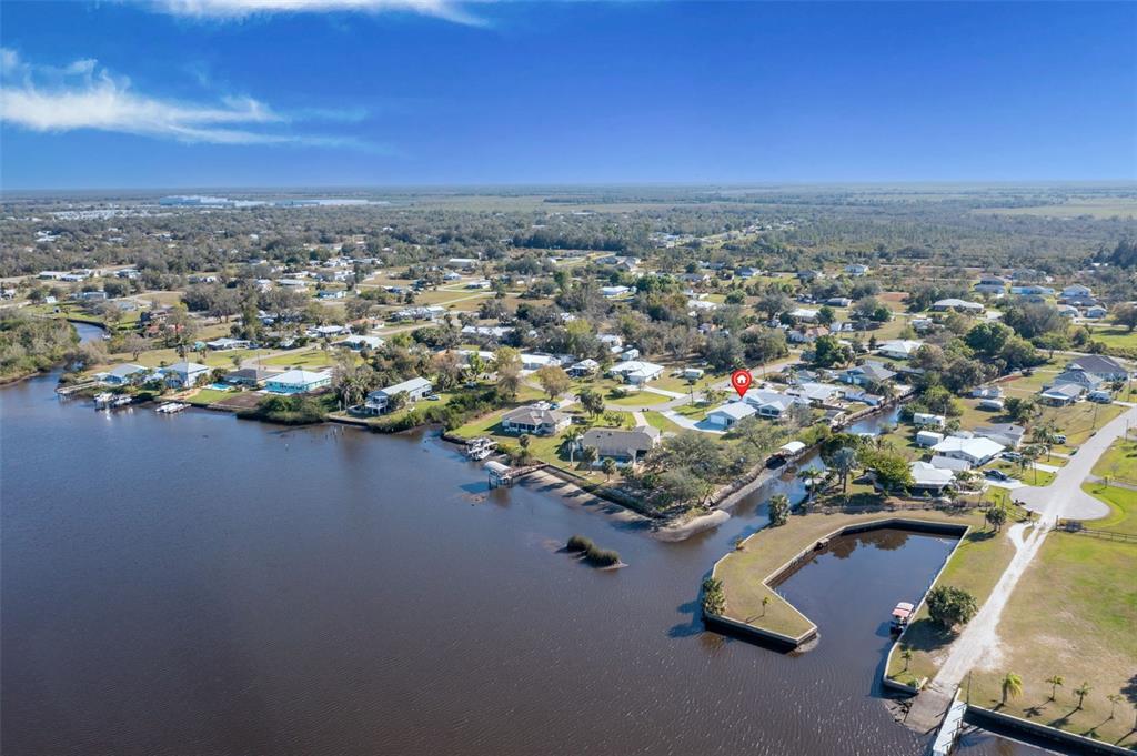 An aerial view shows a waterfront residential neighborhood with a red pin marking a house — 541 RIDGECREST DRIVE, PUNTA GORDA, FL
