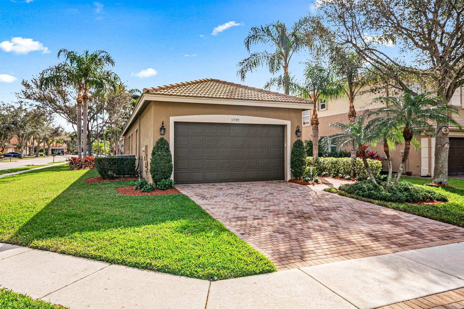 A detached garage with a brown door and a brick paver driveway sits on a lawn — 11546 Ponywalk Trail, Boynton Beach FL 33473, BOYNTON BEACH, FL