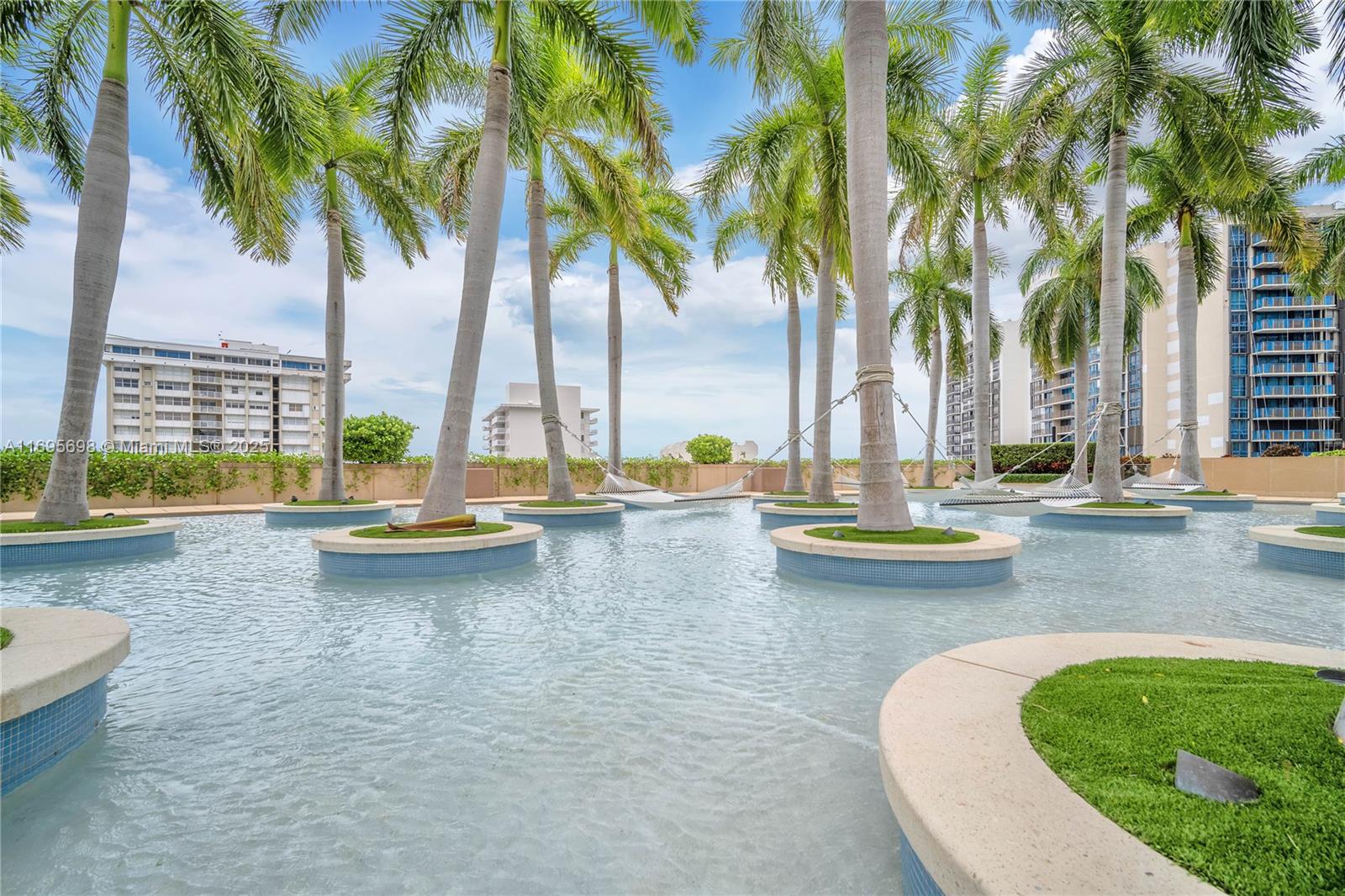 A shallow pool features circular planters with palm trees and hammocks between them — 1435 Brickell Ave # 3012, Miami FL 33131, MIAMI, FL