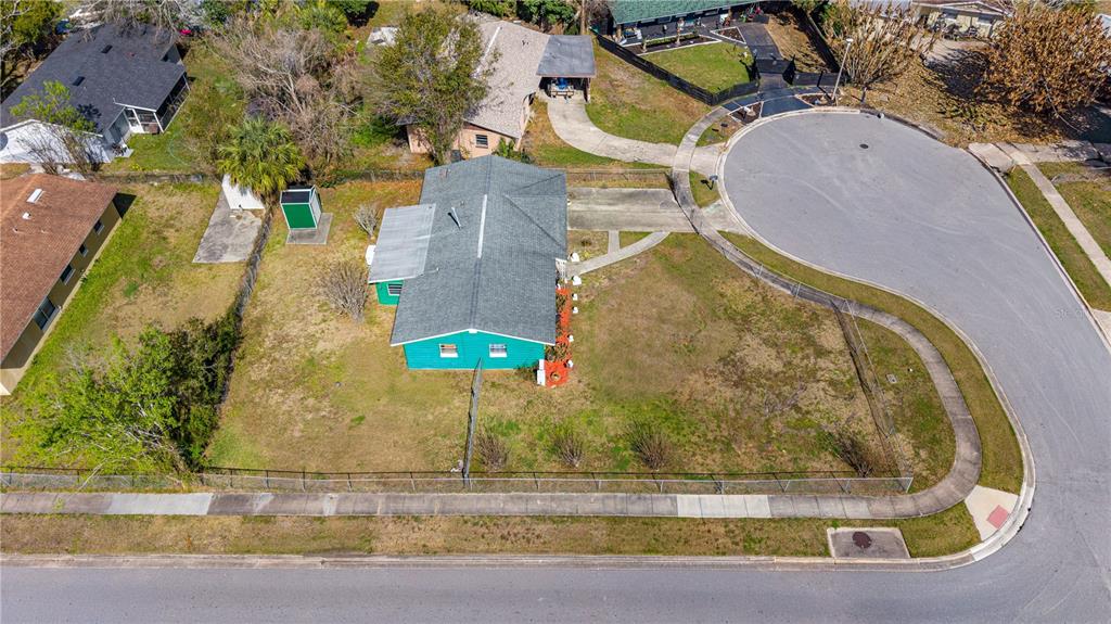 An aerial view shows a green house with a driveway located on a corner lot — 808 KATHY STREET, DAYTONA BEACH, FL