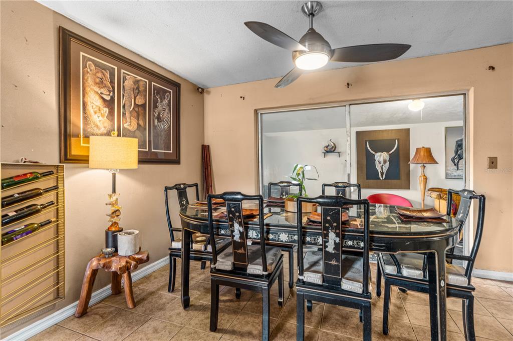A kitchen features wood cabinets, a stainless steel stove, a refrigerator, and tile flooring — 808 KATHY STREET, DAYTONA BEACH, FL