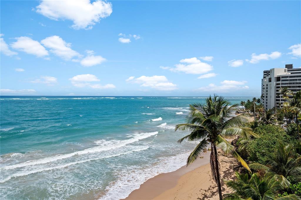 An elevated view of a sandy beach, ocean waves, and a multi-story building — 1 CERVANTES STREET UNIT 5, SAN JUAN, PR