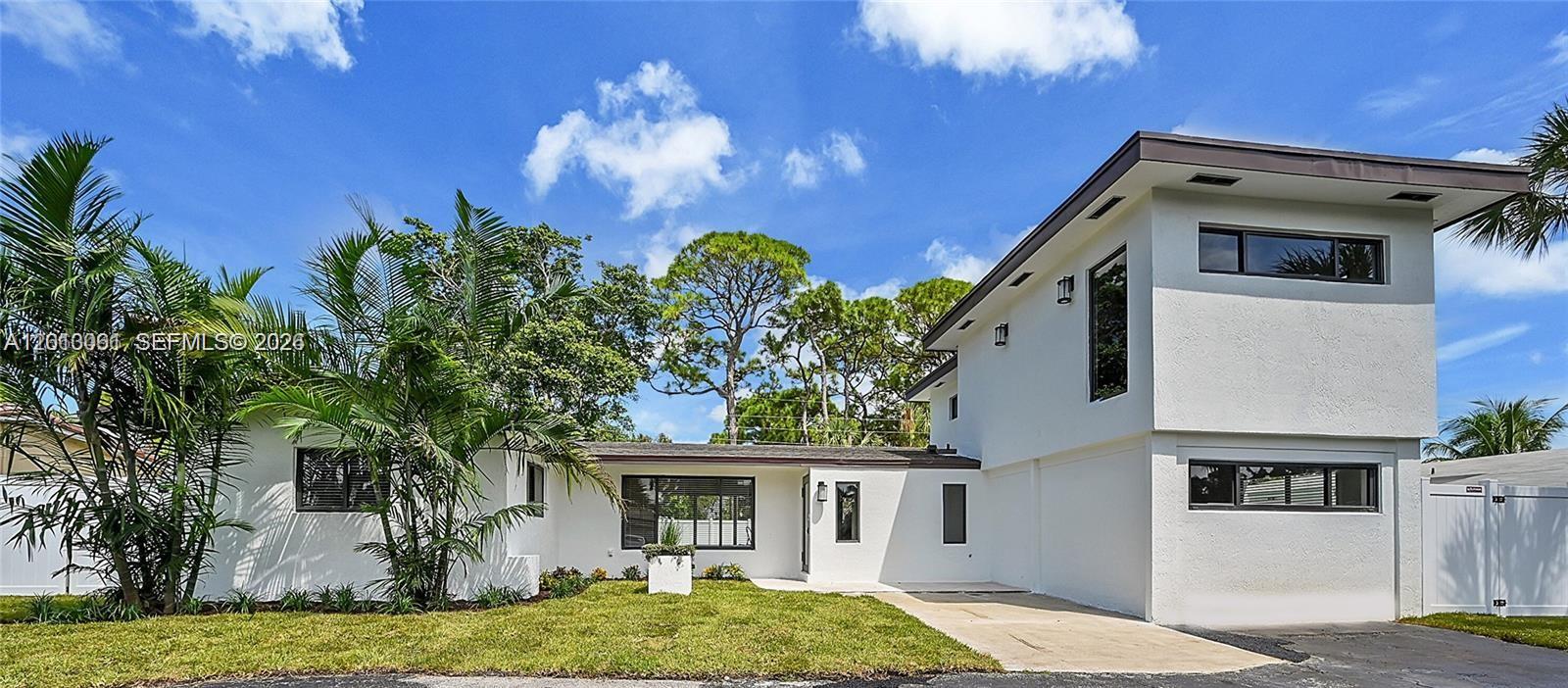 A two-story white house with a flat roof and a concrete driveway — 151 SE 6th Ct, Pompano Beach FL 33060, POMPANO BEACH, FL