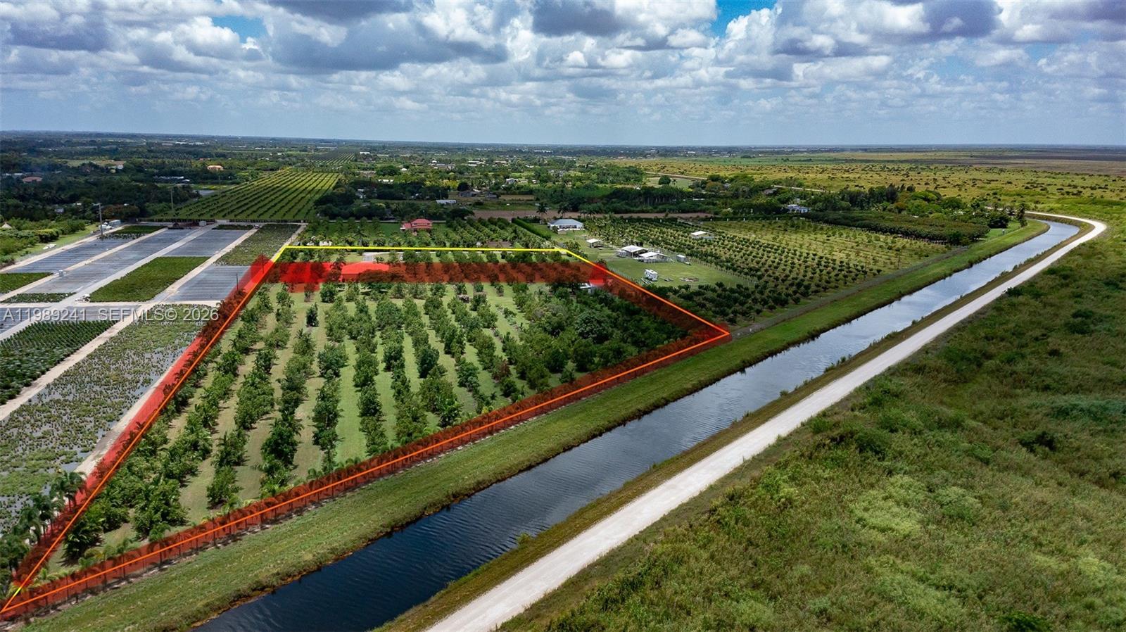 An aerial view shows a rectangular orchard property bordered by a canal and road — xxxxx SW 184 st, Miami FL 33187, MIAMI, FL