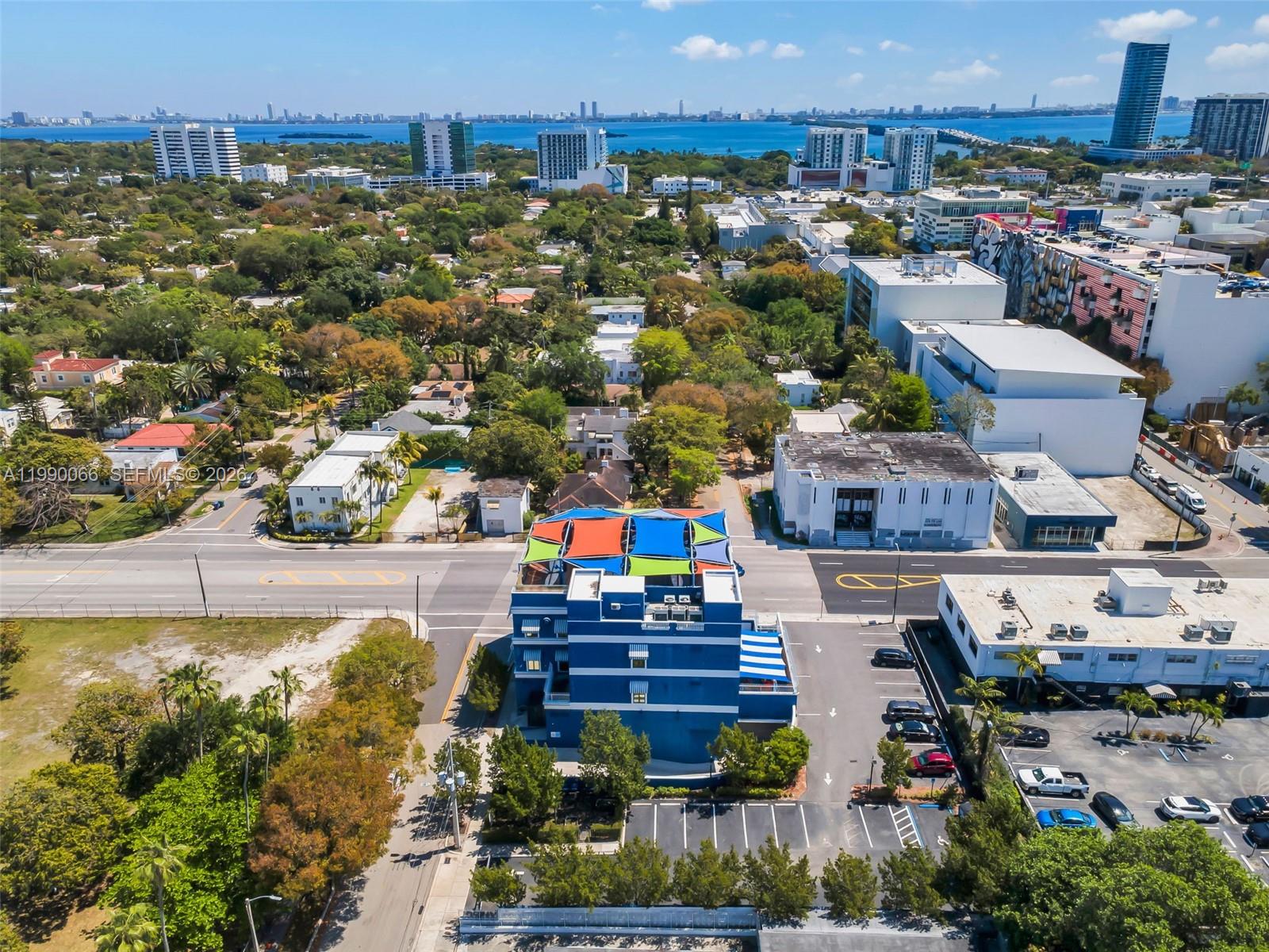 An aerial view shows a blue building with colorful shade sails on its rooftop — 4136 N Miami Ave, Miami FL 33127, MIAMI, FL