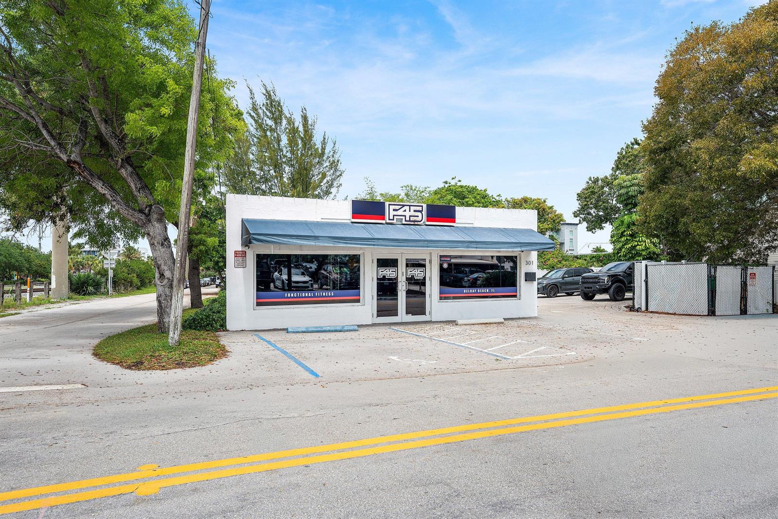 A white commercial building with an F45 fitness studio sign and a blue awning — 301 NE 1st Street, Delray Beach FL 33483, DELRAY BEACH, FL