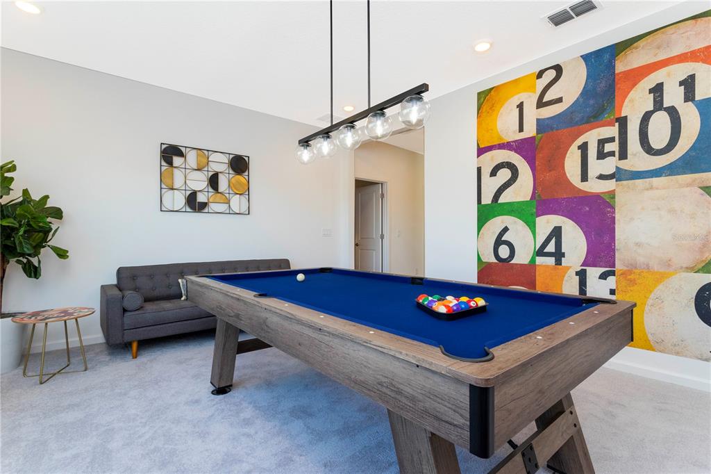 A game room features a pool table, a grey sofa, and a large billiard-themed wall mural — 2569 SHANTI DRIVE, KISSIMMEE, FL