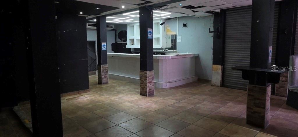 An interior view of a commercial space featuring a bar, tiled floors, and support columns — William AVE BORINQUEN ESQ, BO OBRERO, PR