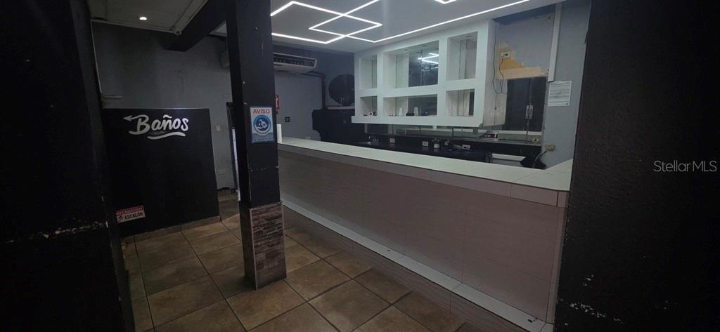 A commercial bar area features a long counter, tiled flooring, and overhead geometric lighting — William AVE BORINQUEN ESQ, BO OBRERO, PR