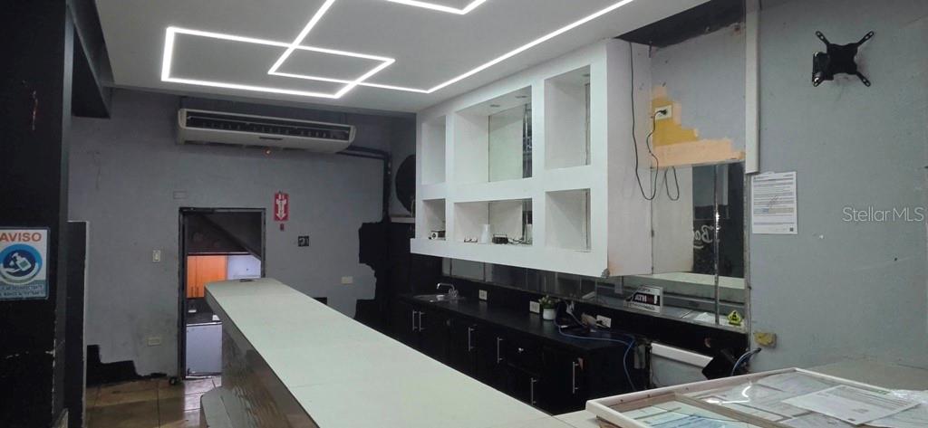A commercial bar area features a long counter, white cabinetry, and geometric ceiling lighting — William AVE BORINQUEN ESQ, BO OBRERO, PR