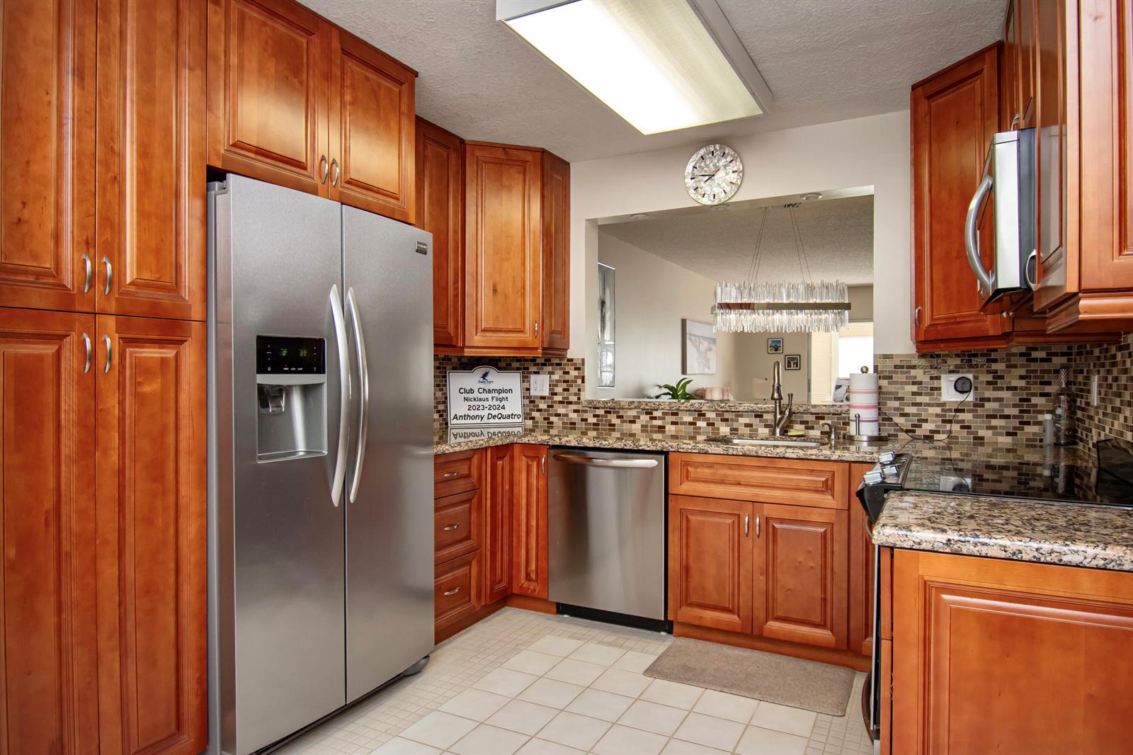 A kitchen with wood cabinets, stainless steel appliances, granite countertops, and a tiled floor — 7286 Huntington Lane # 408, Delray Beach FL 33446, DELRAY BEACH, FL