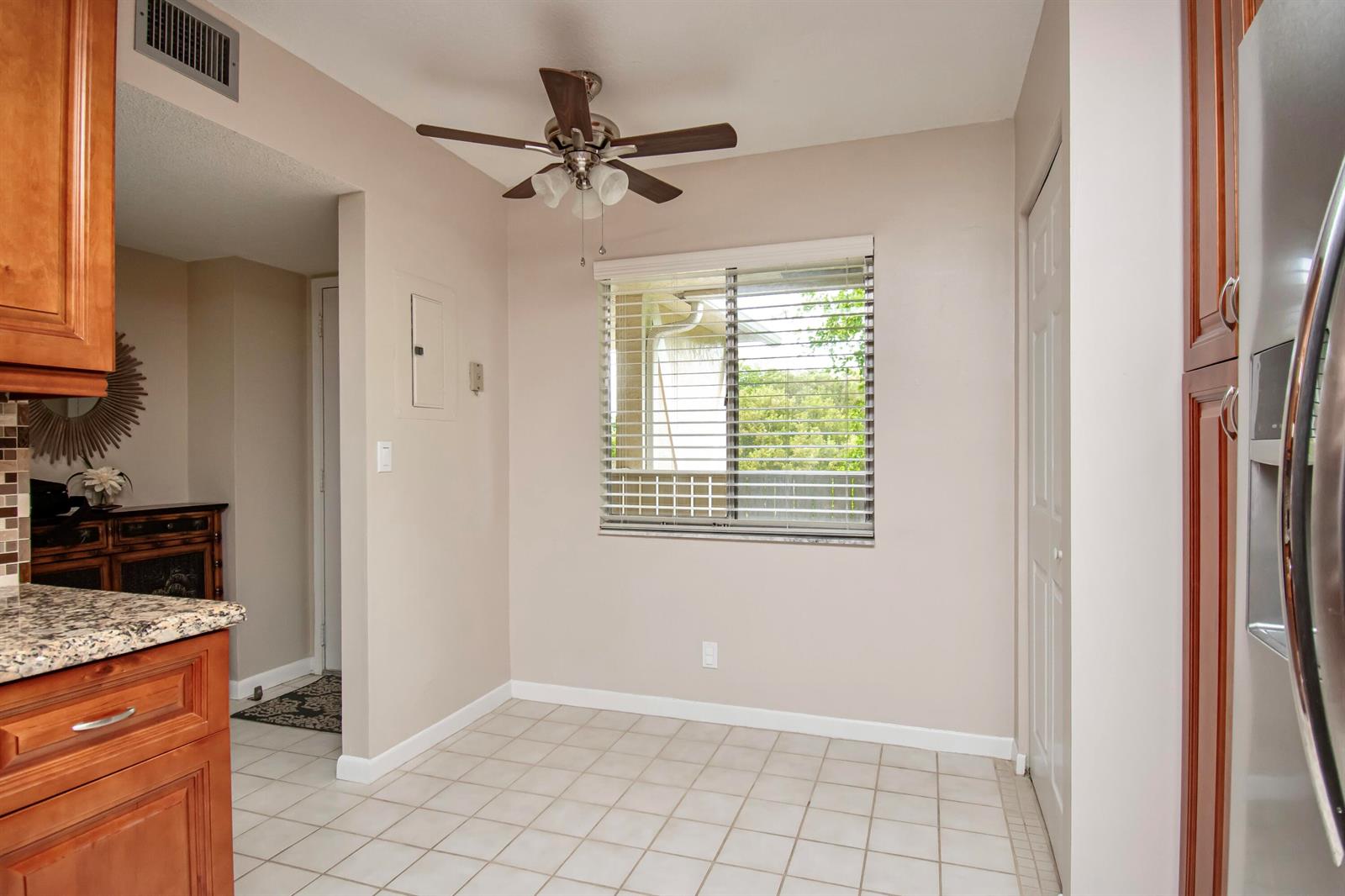 A kitchen dining area with tile floors, a ceiling fan, and a window with blinds — 7286 Huntington Lane # 408, Delray Beach FL 33446, DELRAY BEACH, FL