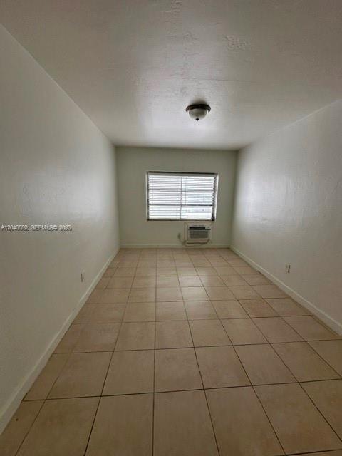 An empty room with white walls, tiled flooring, a window with blinds, and a ceiling light — 30 S Shore Dr # 4, Miami Beach FL 33141, MIAMI BEACH, FL