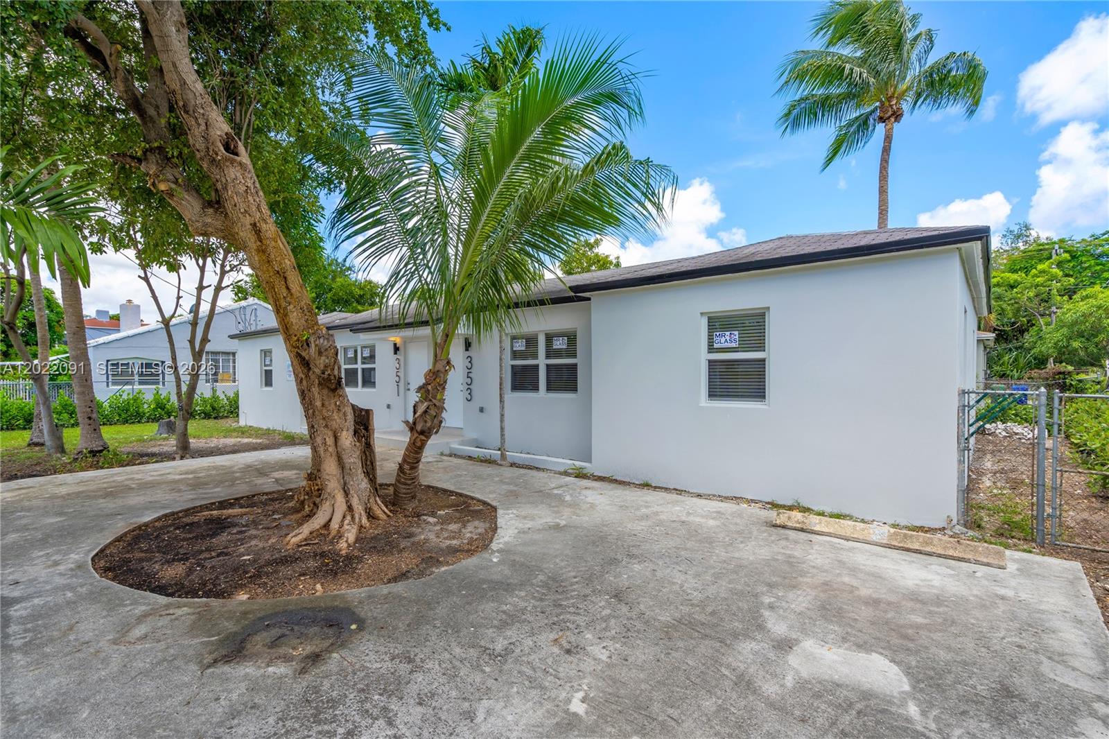 A white single-story house with a concrete driveway and palm trees in the front yard — 351 NE 82nd St # 1, Miami FL 33138, MIAMI, FL
