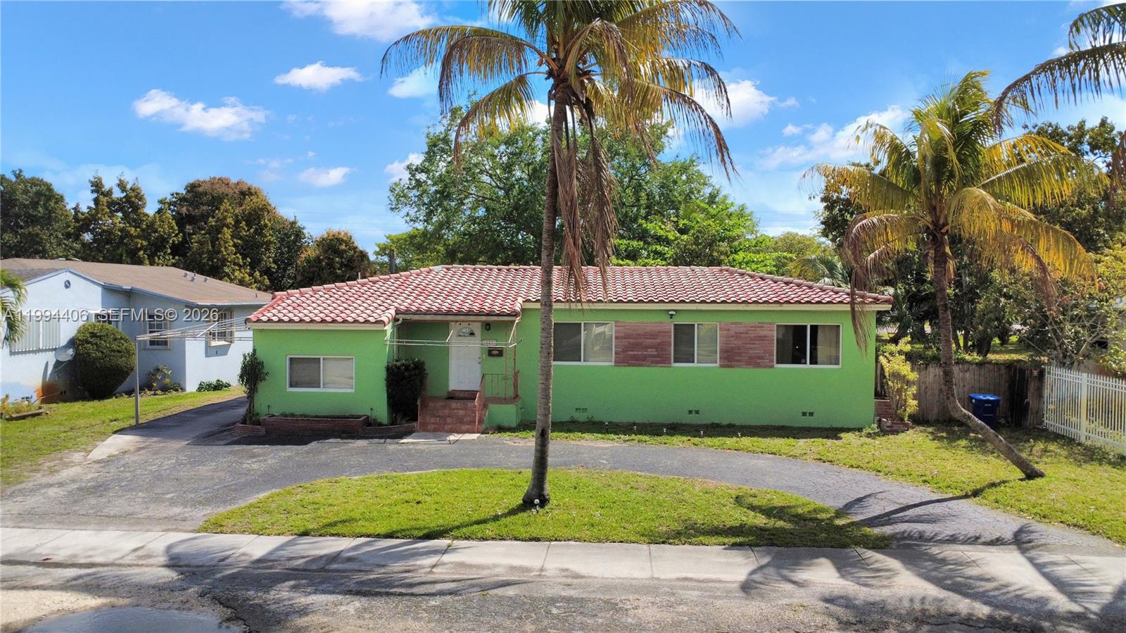 A single-story lime green house with a red tile roof and a curved driveway — 12901 NW Miami Ct, Miami FL 33168, MIAMI, FL