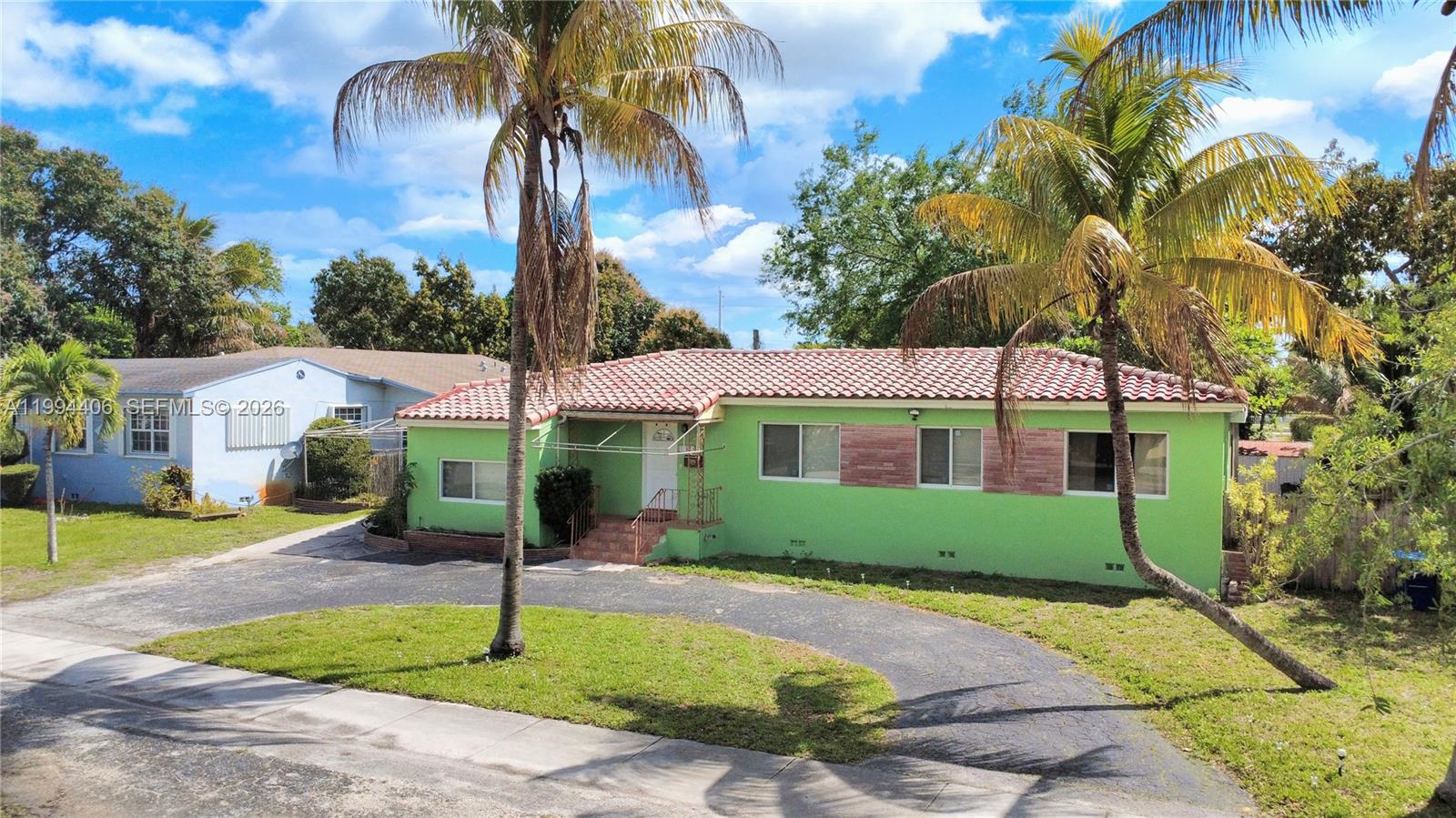A lime green single-story house with a red tile roof and a curved driveway — 12901 NW Miami Ct, Miami FL 33168, MIAMI, FL