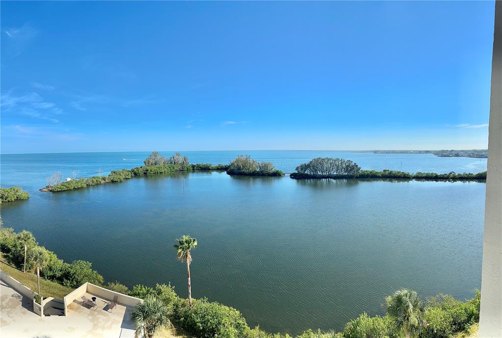 An elevated view of a calm bay with mangrove islands under a clear blue sky — 5915 SEA RANCH DRIVE UNIT 711, HUDSON, FL