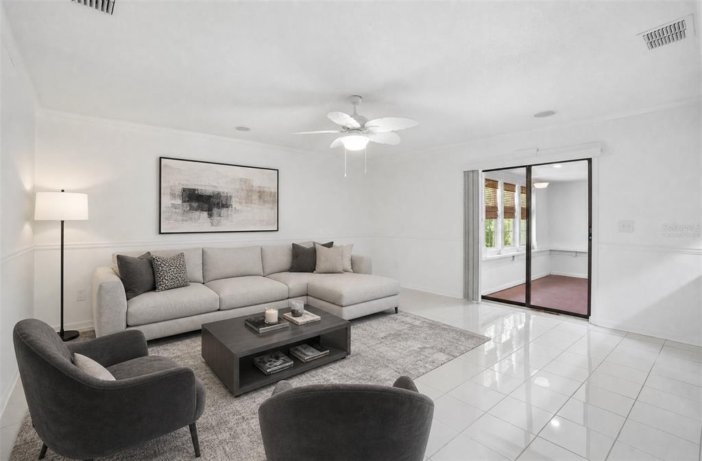 A living room features a sectional sofa, two armchairs, a coffee table, and tile flooring — 222 LAKEVIEW DRIVE, AUBURNDALE, FL