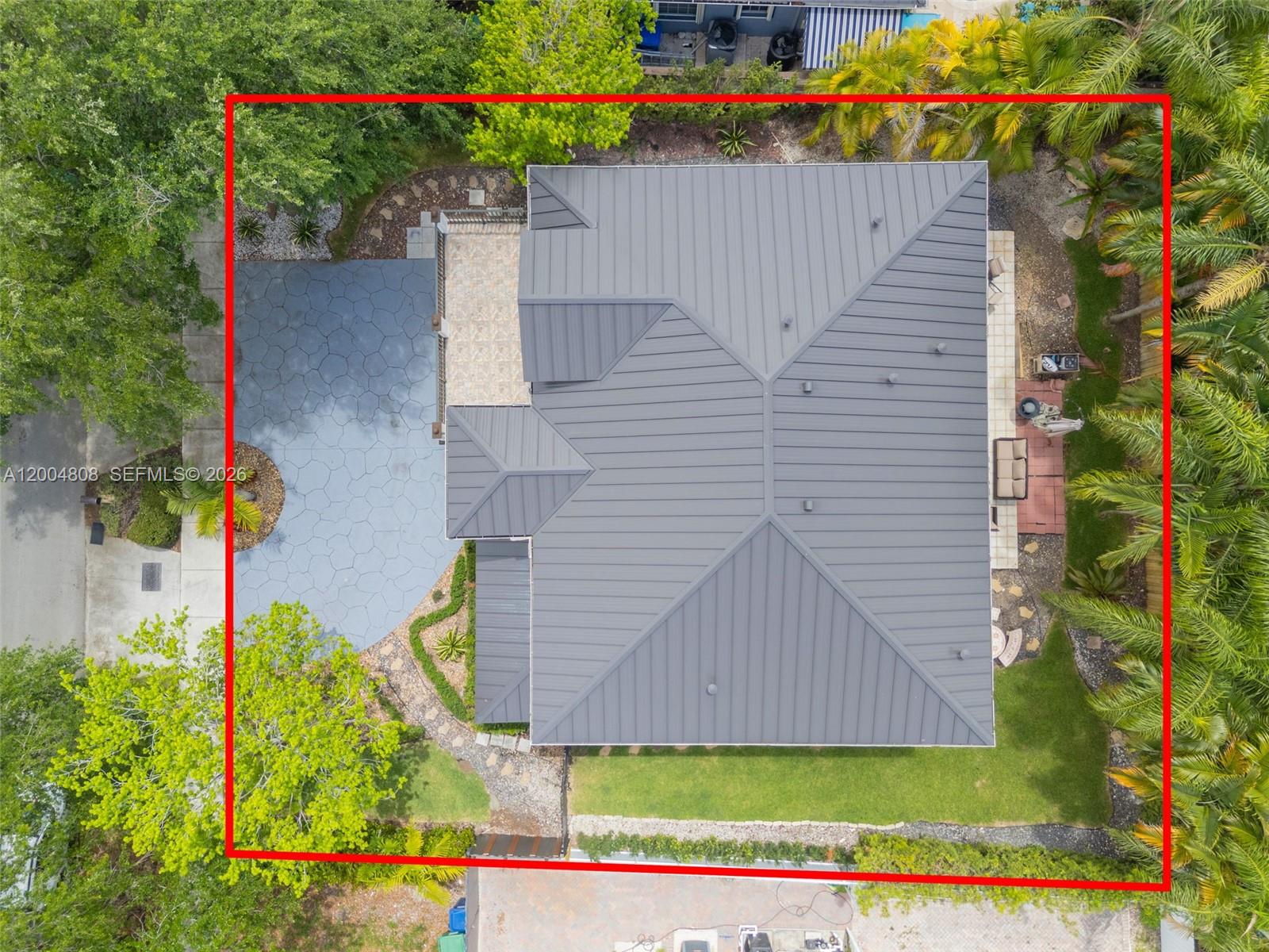 An aerial view shows a house with a dark metal roof and a paved driveway — 16230 NW 84th Ct, Miami Lakes FL 33016, MIAMI LAKES, FL
