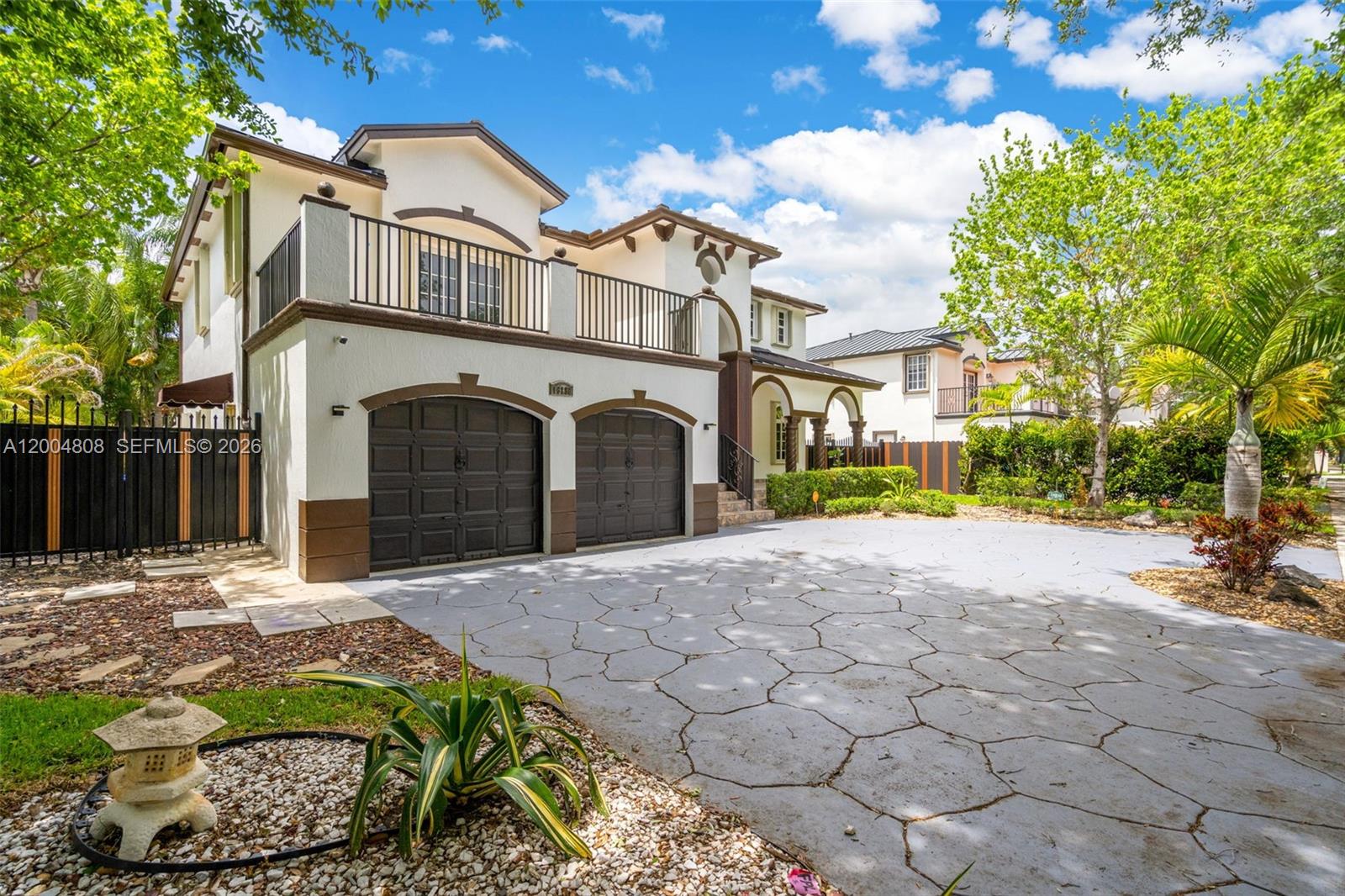 A two-story house features a two-car garage, a second-floor balcony, and a paved driveway — 16230 NW 84th Ct, Miami Lakes FL 33016, MIAMI LAKES, FL