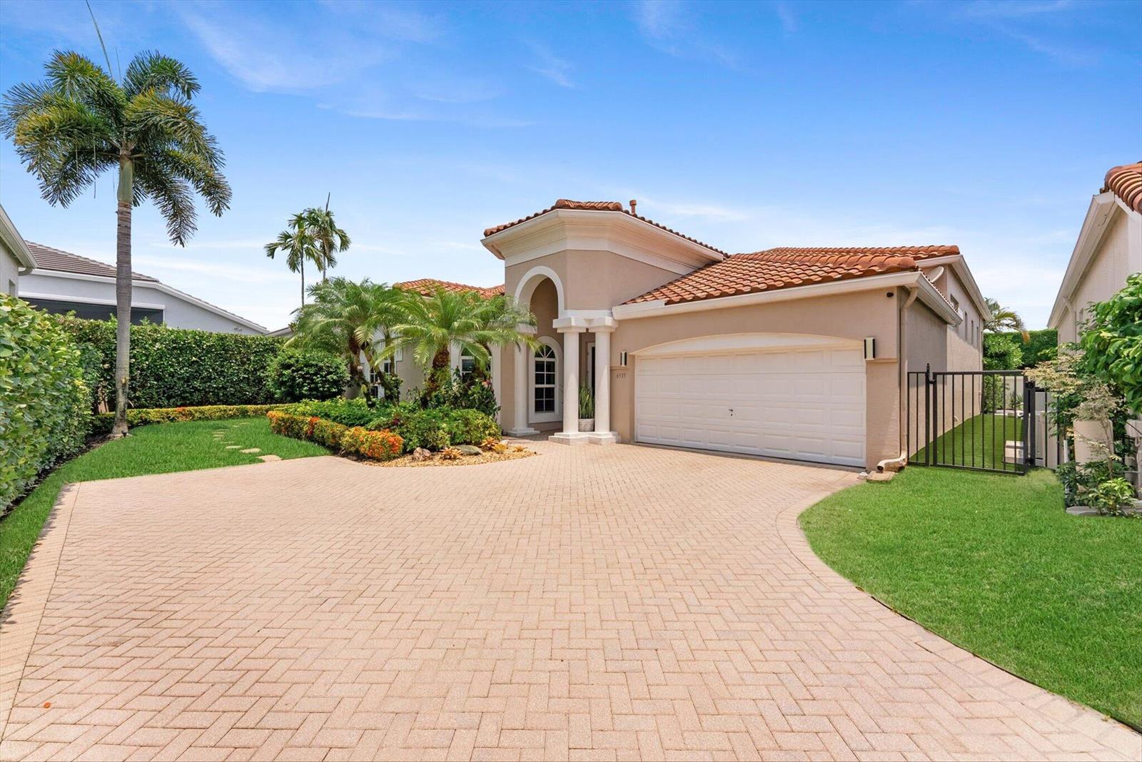 A beige single-story house with a tiled roof, a paved driveway, and a palm tree — 6533 Somerset Circle, Boca Raton FL 33496, BOCA RATON, FL