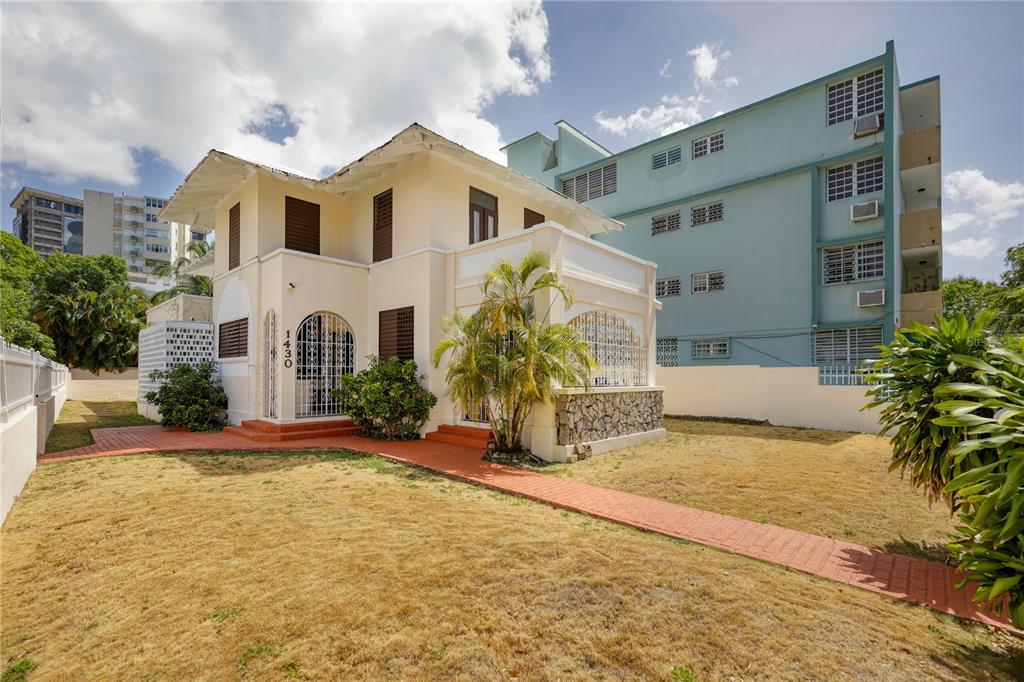 A two-story cream-colored house with a red brick walkway and a large front yard — 1430 WILSON STREET, SAN JUAN, PR