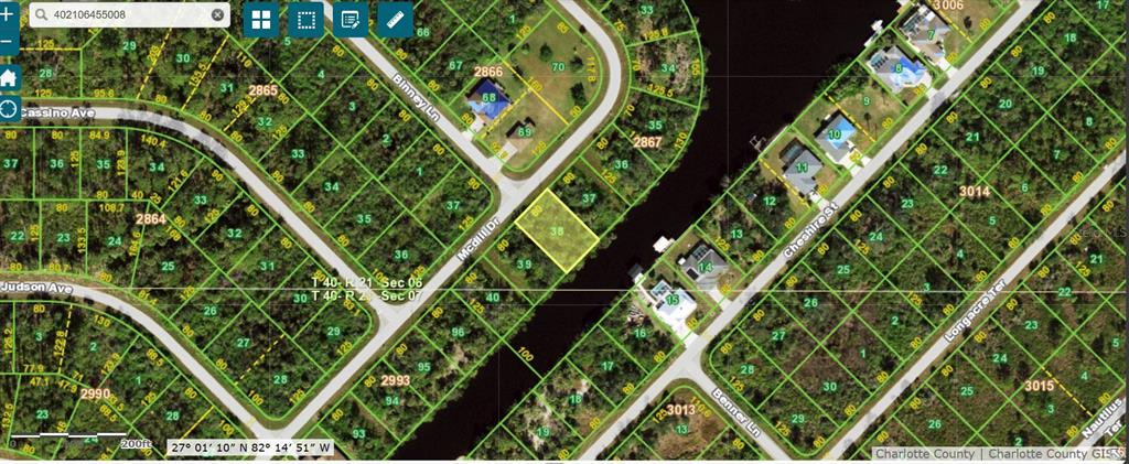 This is a satellite map showing a vacant residential lot highlighted in yellow near a canal — 602 MCDILL DRIVE, PORT CHARLOTTE, FL