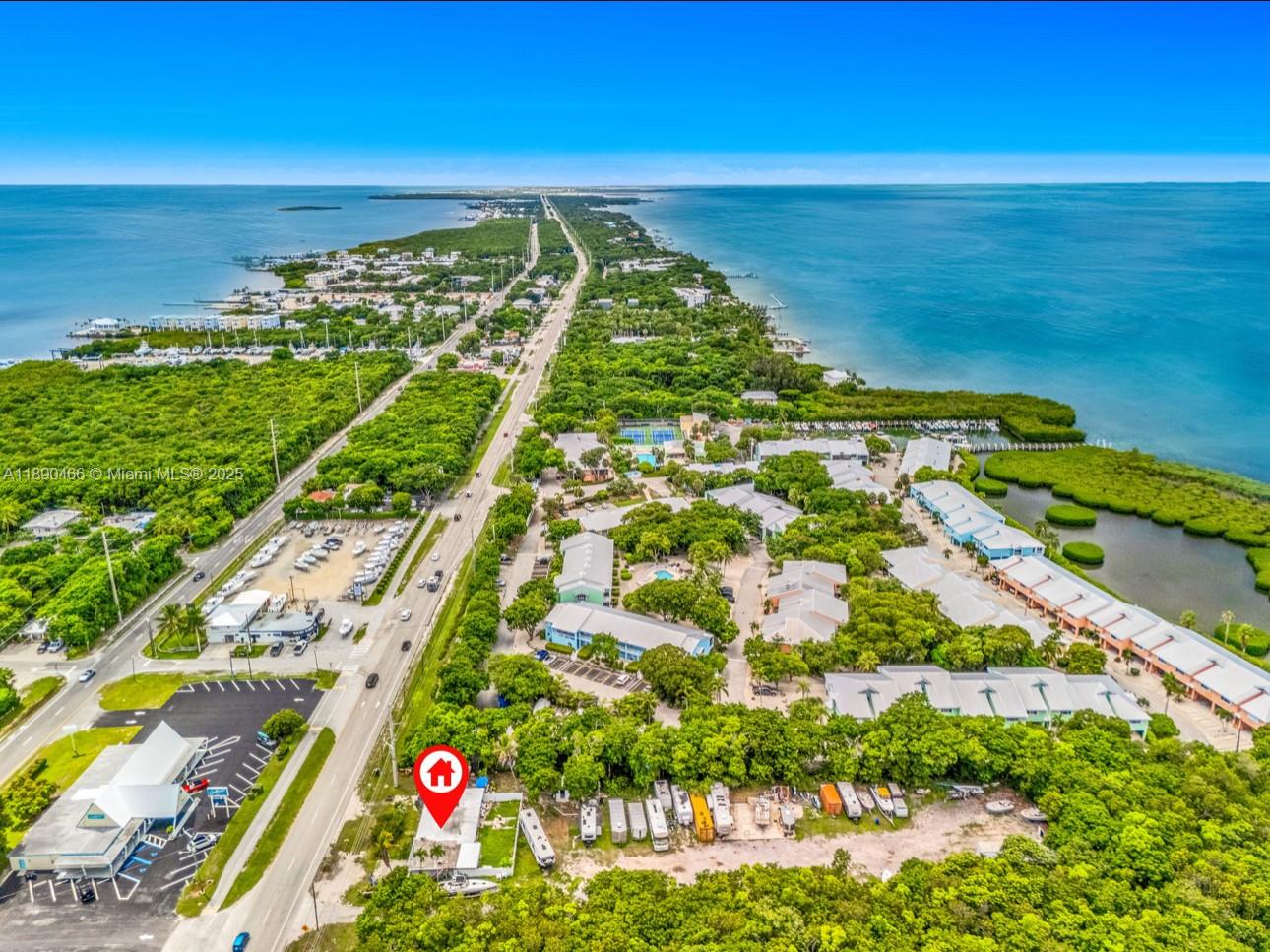 An aerial view shows a coastal property with a red location pin near a highway — 98468 Overseas Hwy, Key Largo FL 33037, KEY LARGO, FL