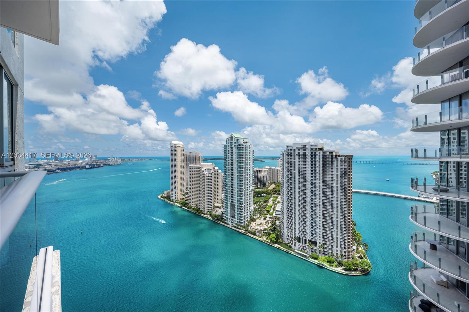 An elevated view of high-rise apartment buildings situated on a peninsula surrounded by blue water — 300 S Biscayne Blvd # 3406, Miami FL 33131, MIAMI, FL