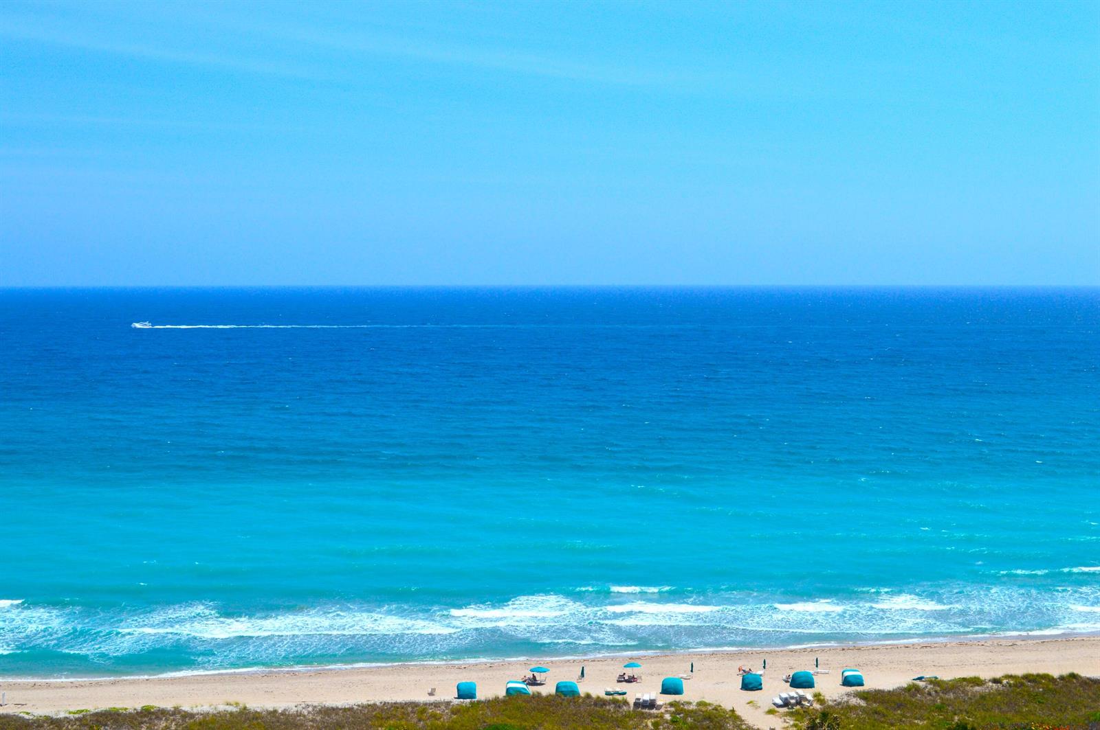 An elevated view of a sandy beach, turquoise ocean, and a boat on the horizon — 4101 N Ocean Boulevard # 703, Boca Raton FL 33431, BOCA RATON, FL
