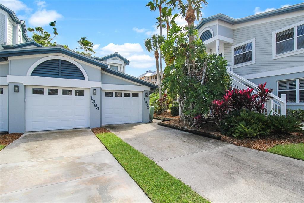 A two-car garage with a light blue exterior and a concrete driveway — 1364 SIESTA BAYSIDE DRIVE UNIT 1364-C, SARASOTA, FL