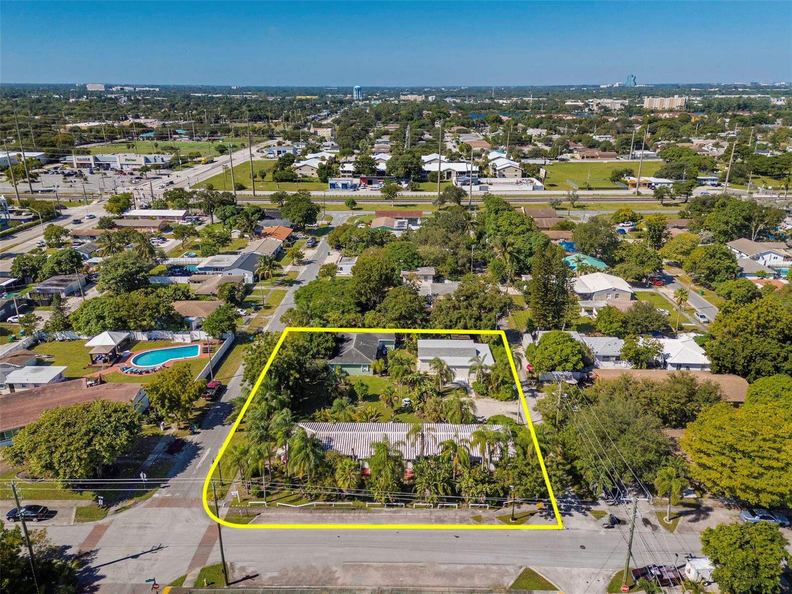 An aerial view shows a residential lot with multiple buildings and palm trees outlined in yellow — 302 SW 15th Street, Dania Beach FL 33004, DANIA BEACH, FL