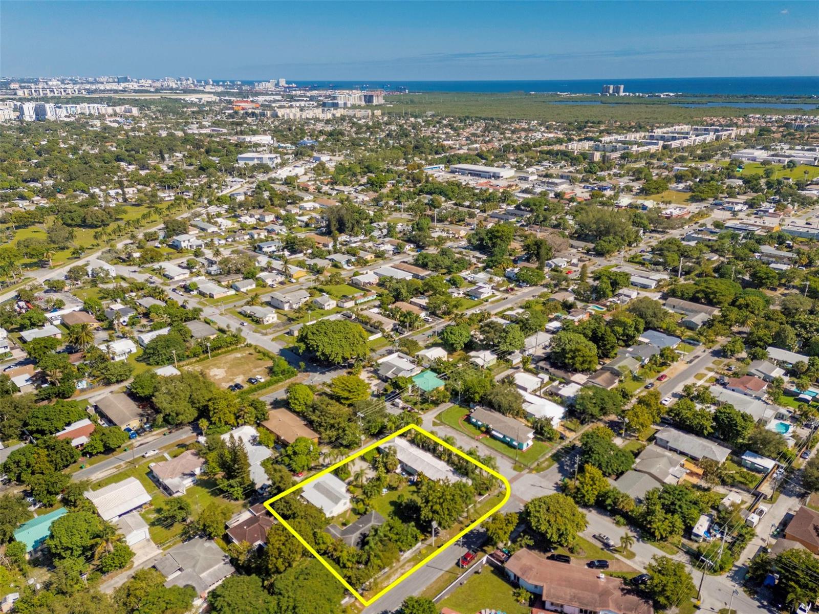 An aerial view shows a residential property highlighted in yellow within a suburban neighborhood — 302 SW 15th Street, Dania Beach FL 33004, DANIA BEACH, FL