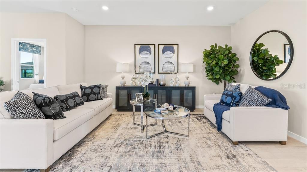 A living room features two white sofas, a central coffee table, and a dark sideboard — 16343 STONEFRONT LANE, PORT CHARLOTTE, FL