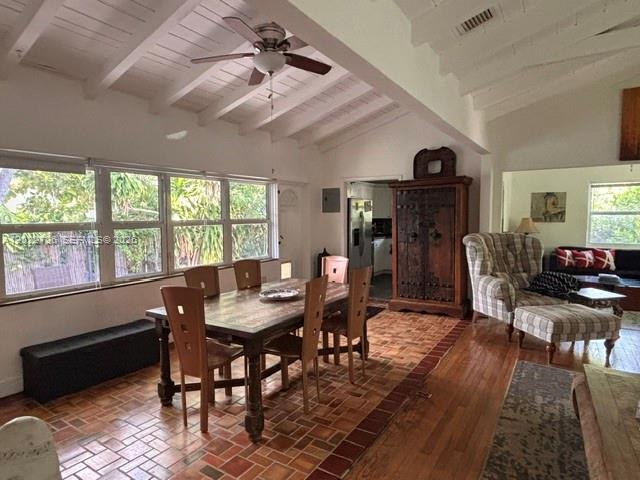 A dining area with a wooden table and chairs sits on a terracotta tile floor — 8228 NE 8th Ct, Miami FL 33138, MIAMI, FL