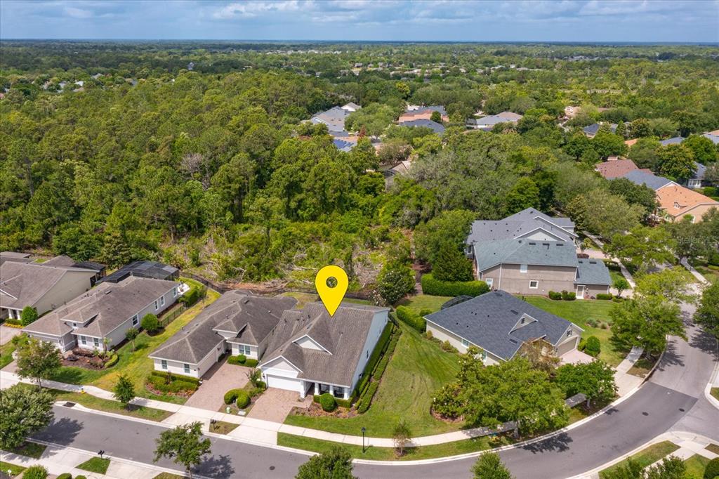 An aerial view shows a suburban house with a yellow location pin on its roof — 1634 VICTORIA GARDENS DRIVE, DELAND, FL