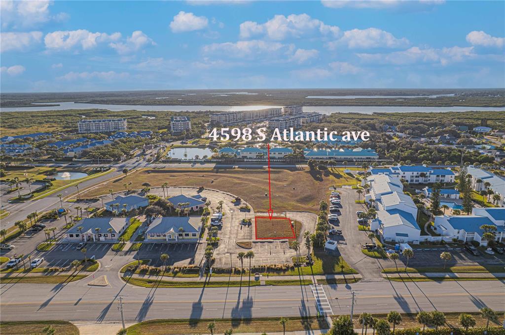 An aerial view shows a vacant rectangular lot outlined in red within a parking area — 4598 S ATLANTIC AVENUE, PORT ORANGE, FL