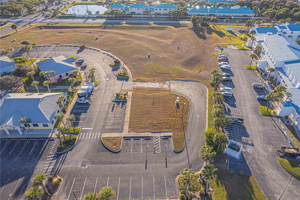 An aerial view shows a vacant lot surrounded by parking lots and commercial buildings — 4598 S ATLANTIC AVENUE, PORT ORANGE, FL