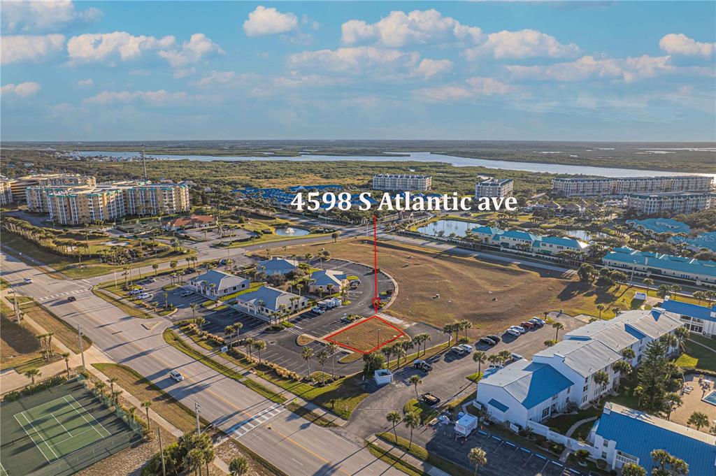 An aerial view shows a vacant rectangular lot outlined in red within a parking area — 4598 S ATLANTIC AVENUE, PORT ORANGE, FL