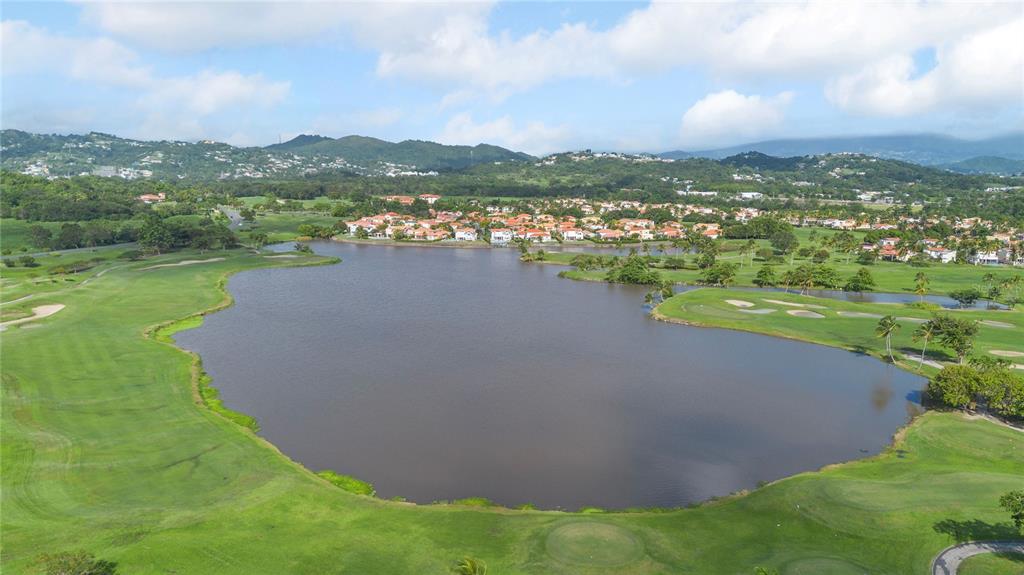 An aerial view of a large lake surrounded by a golf course and residential homes — 49 LOS LAGOS, HUMACAO, PR