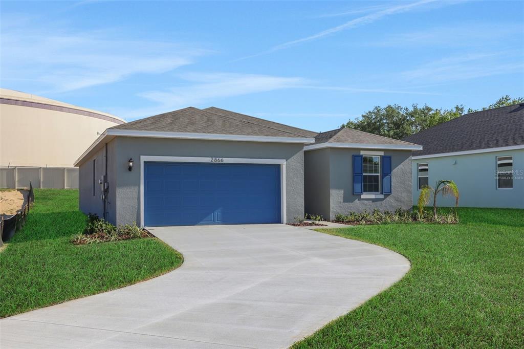 A concrete patio overlooks a grassy backyard enclosed by a white vinyl fence — 2866 SUPERMARINE ROAD, TAVARES, FL