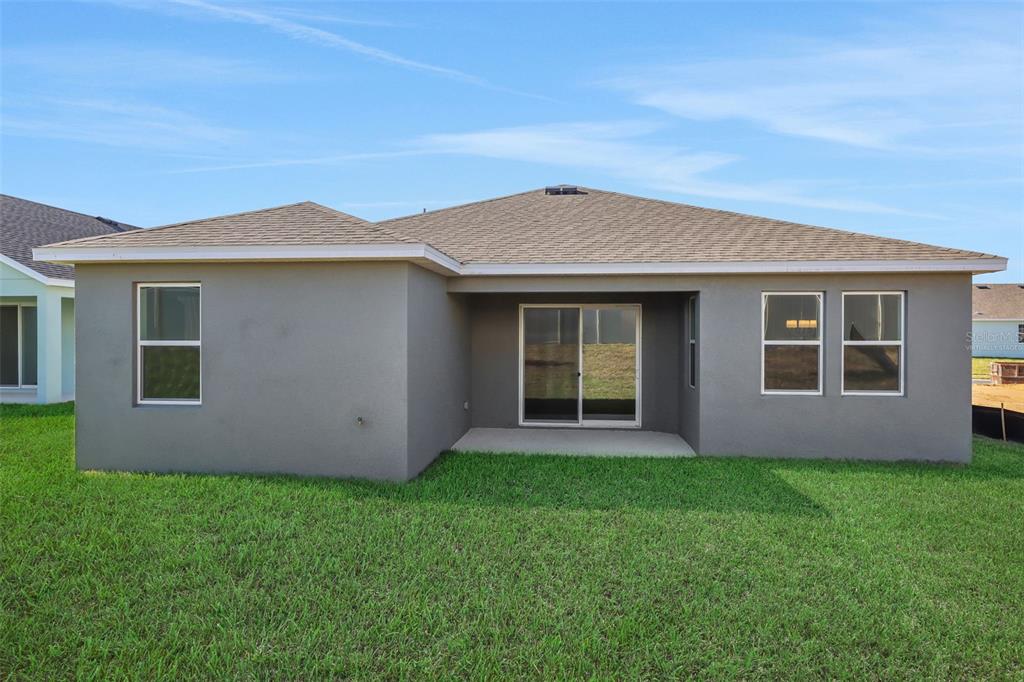 A bright entryway features light wood flooring, white walls, and a central white front door — 2866 SUPERMARINE ROAD, TAVARES, FL